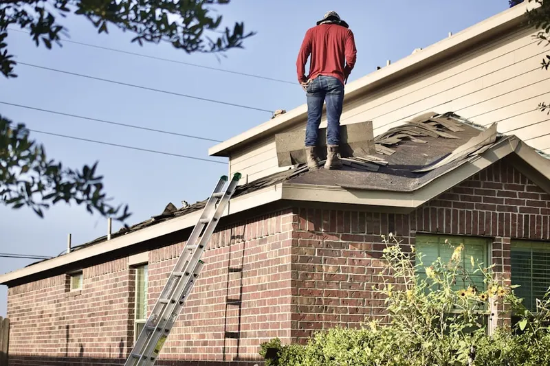 Professional roofer working on a residential roof in Olde West Chester